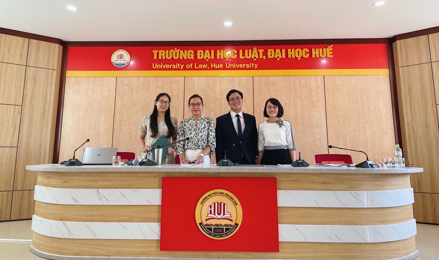 A group of people standing behind a counterDescription automatically generated with medium confidence